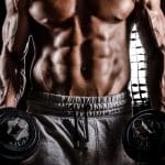 Powerful Body of Athlete Bodybuilder Posing with Dumbbells