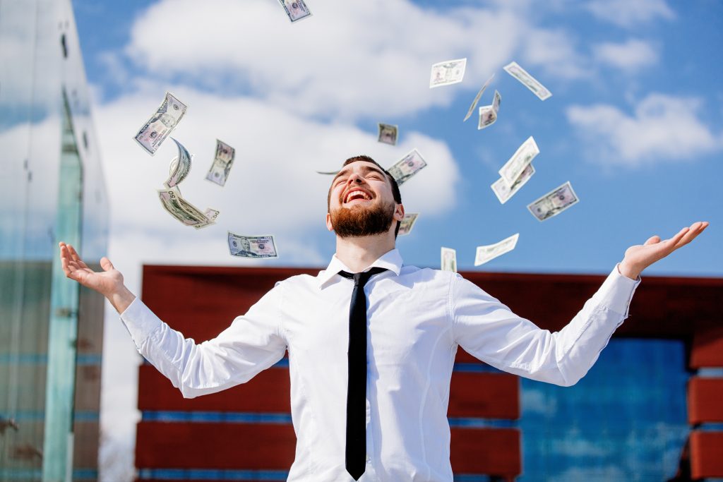 young businessman with falling cash money