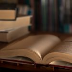 Stack of books on the library. World book day. Knowledge, education and learning concept. Selective focus.