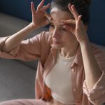 high angle woman practicing facial yoga